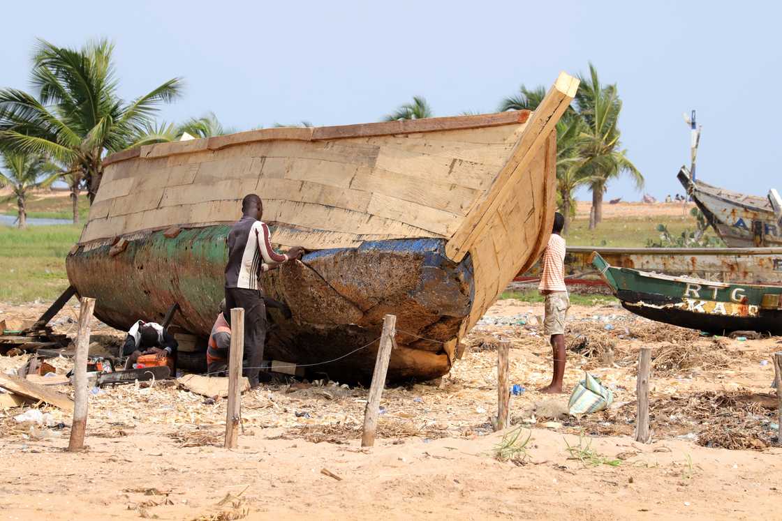 Men repairing a boat Men repairing a boat