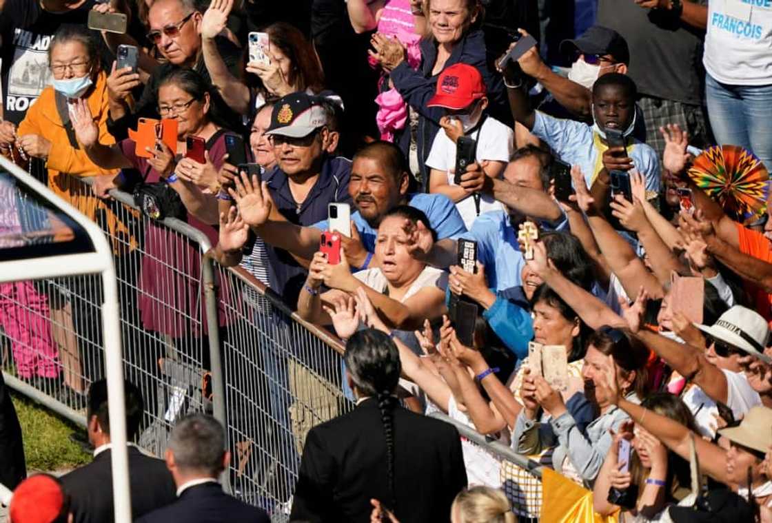 Catholic faithful take pictures and cheer as Pope Francis arrives at the shrine of Sainte-Anne-de-Beaupre in Quebec, Canada on July 28, 2022