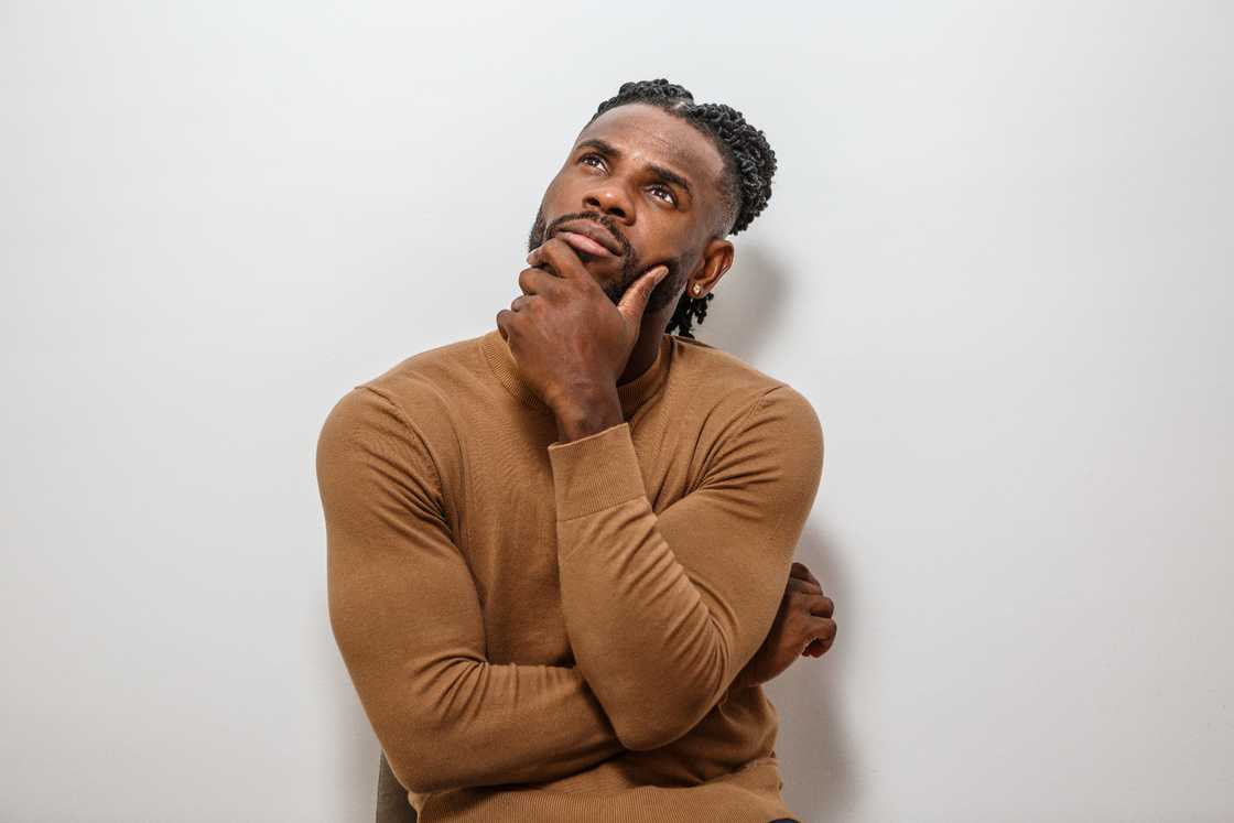 A man sits pensively, deep in thought