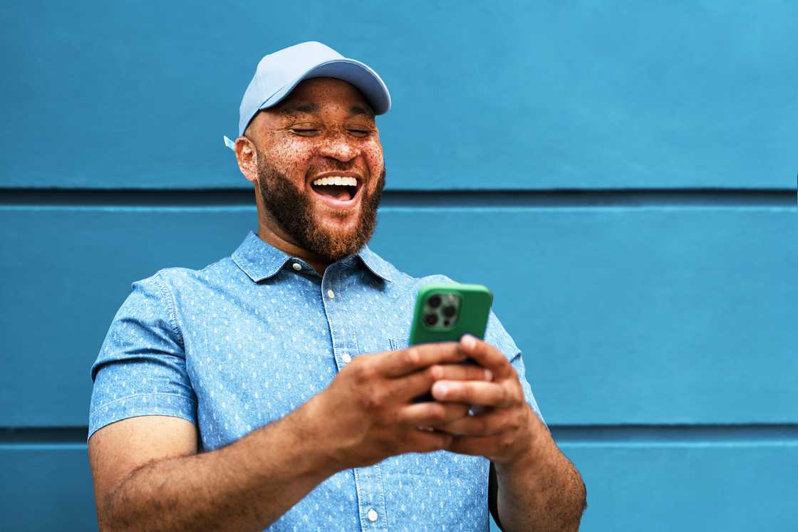 A wearing blue was snapped holding his phone A wearing blue was snapped holding his phone