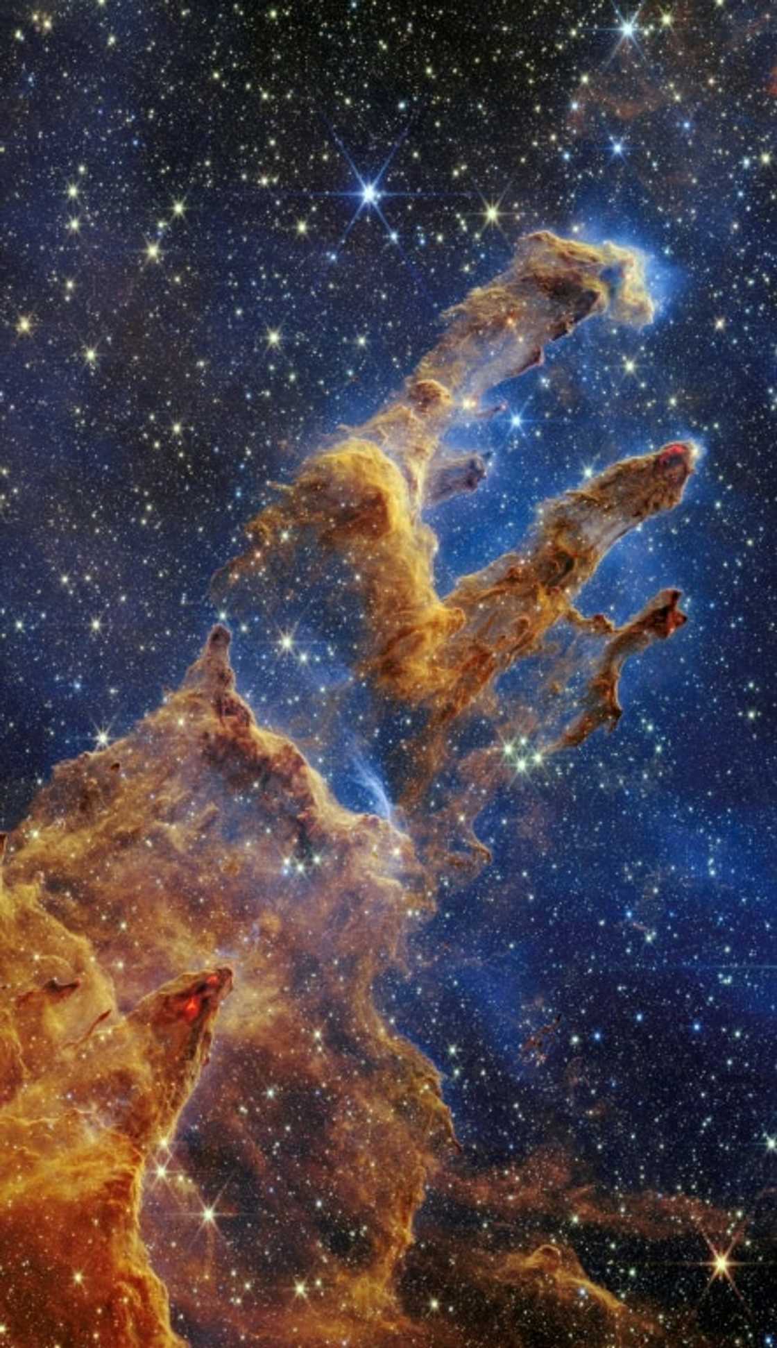 This handout photo provided by NASA on October 19, 2022 shows the 'Pillars of Creation' that are set off in a kaleidoscope of color in the James Webb Space Telescope's near-infrared-light view This handout photo provided by NASA on October 19, 2022 shows the 'Pillars of Creation' that are set off in a kaleidoscope of color in the James Webb Space Telescope's near-infrared-light view
