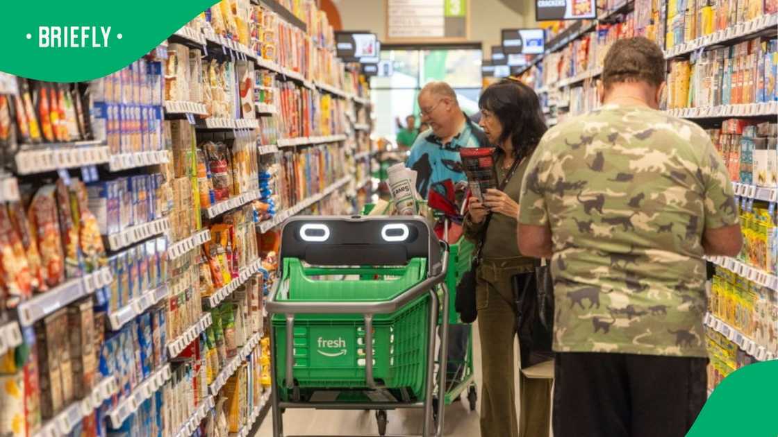 People are shopping for groceries with a smart trolley, which Checkers is testing out.