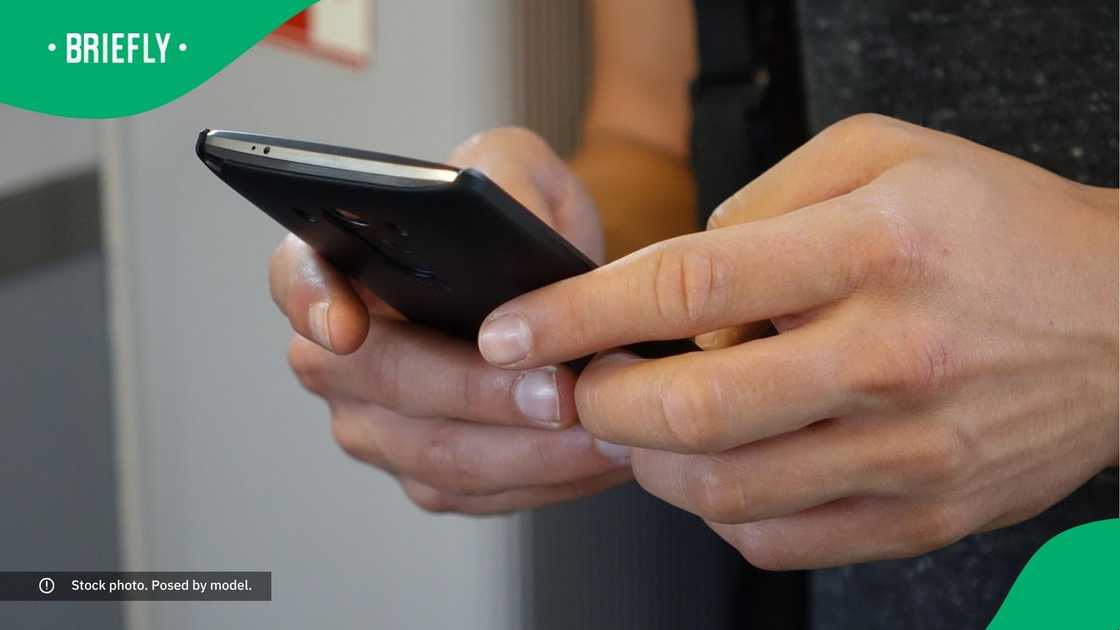 A woman typing on her phone.
