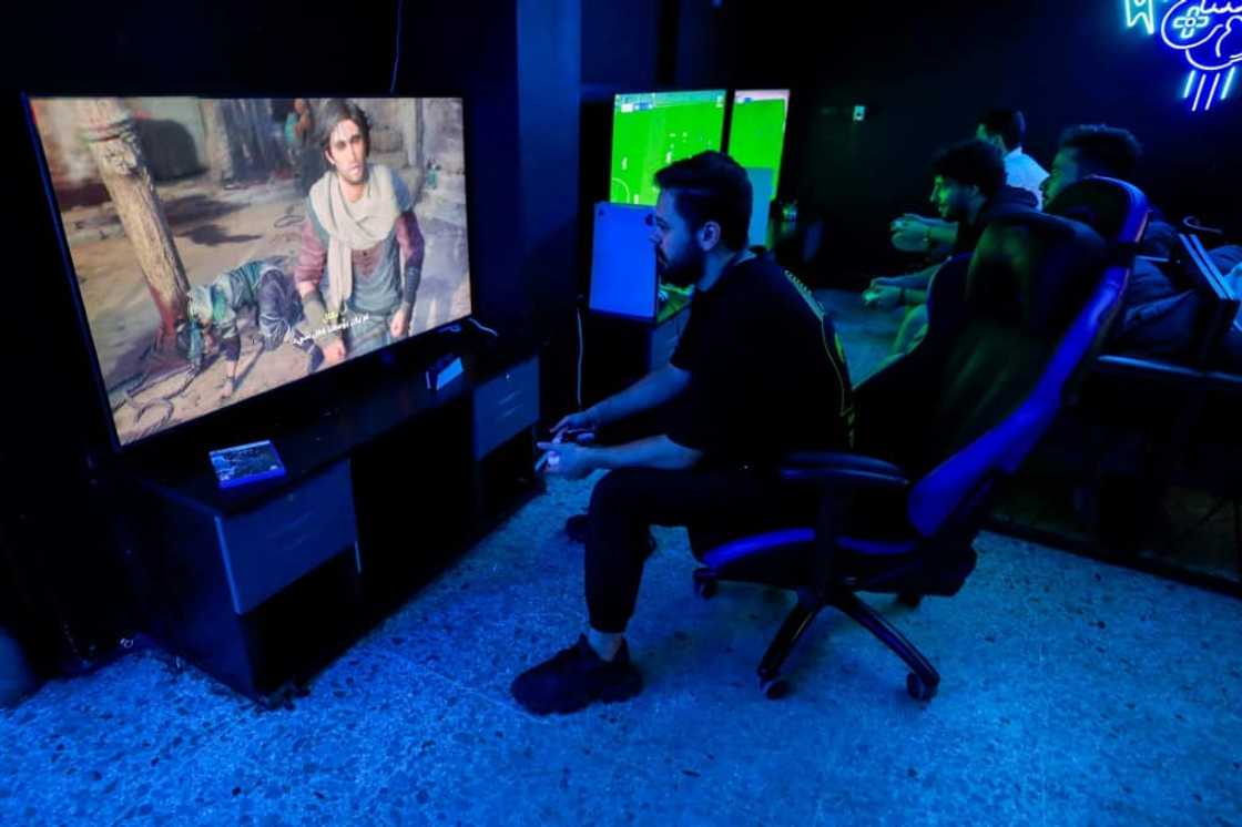 A man plays the newly released video game 'Assassin's Creed Mirage' in a cybercafe in Baghdad on October 4, 2023