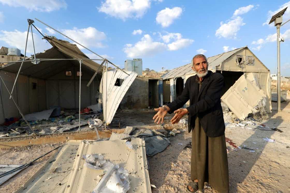A man shows damage caused by the deadly rocket strikes A man shows damage caused by the deadly rocket strikes