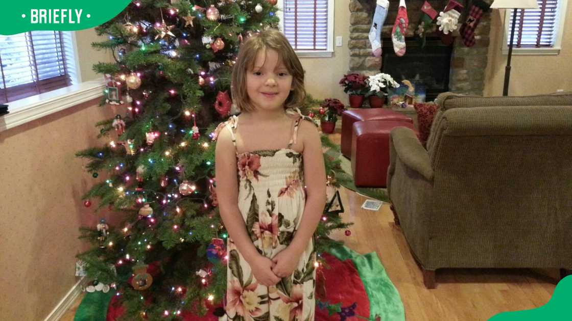 Caitlin Elizabeth Jennings posing in front of a Christmas tree Caitlin Elizabeth Jennings posing in front of a Christmas tree