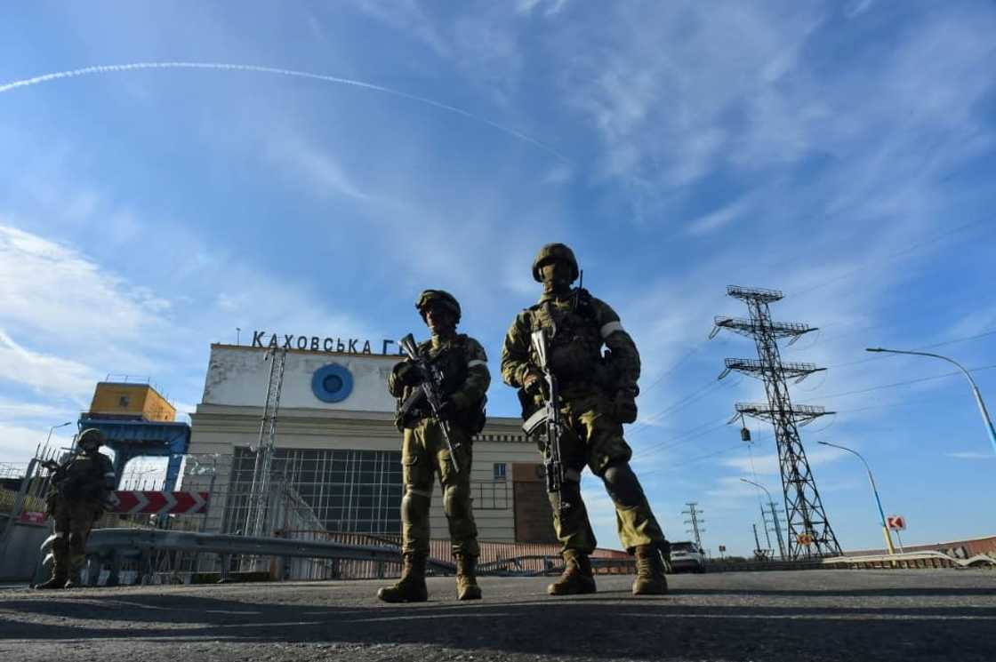 Russians patrol in May at the Kakhovka Hydroelectric Power Plant, which Kyiv says Russian forces plan to blow up, triggering a devastating flood Russians patrol in May at the Kakhovka Hydroelectric Power Plant, which Kyiv says Russian forces plan to blow up, triggering a devastating flood