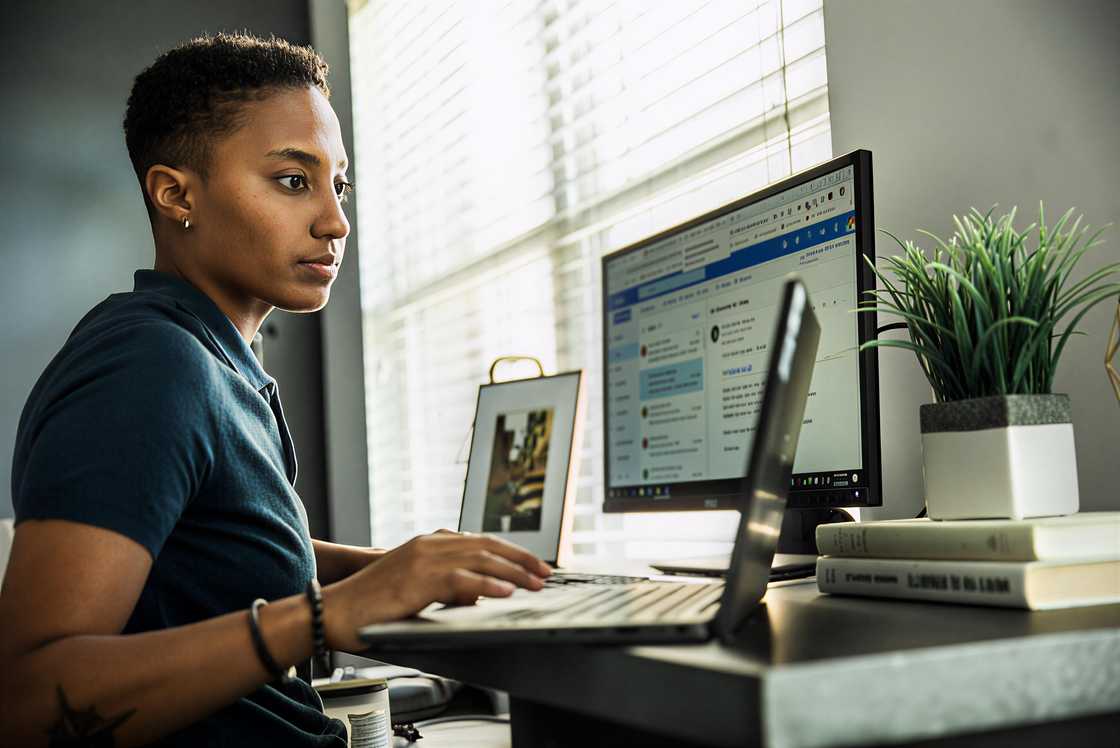A young woman is working on a desktop computer