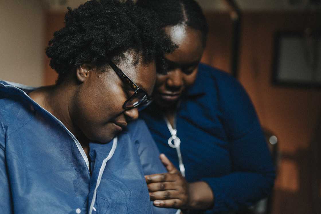 Female friend consoling a worried woman Female friend consoling a worried woman