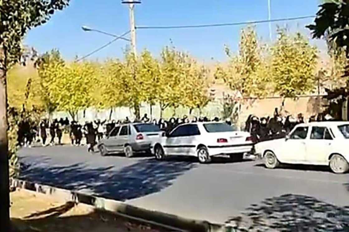 This grab taken from a UGC video made available on the ESN platform on October 4, 2022 shows school students cheering and chanting as they venture out onto the streets of Saqqez city in Iran's Kurdistan province, hometown of Mahsa Amini This grab taken from a UGC video made available on the ESN platform on October 4, 2022 shows school students cheering and chanting as they venture out onto the streets of Saqqez city in Iran's Kurdistan province, hometown of Mahsa Amini