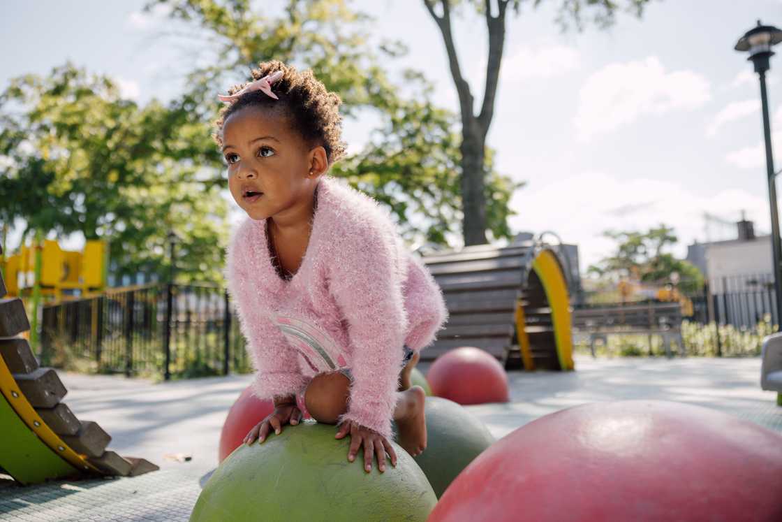 A kid palying in the park A kid palying in the park