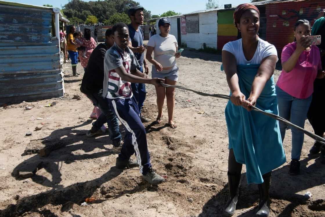 Tug-of-war: residents try to hang on to illegal electricity lines at Oasis Farm near Cape Town