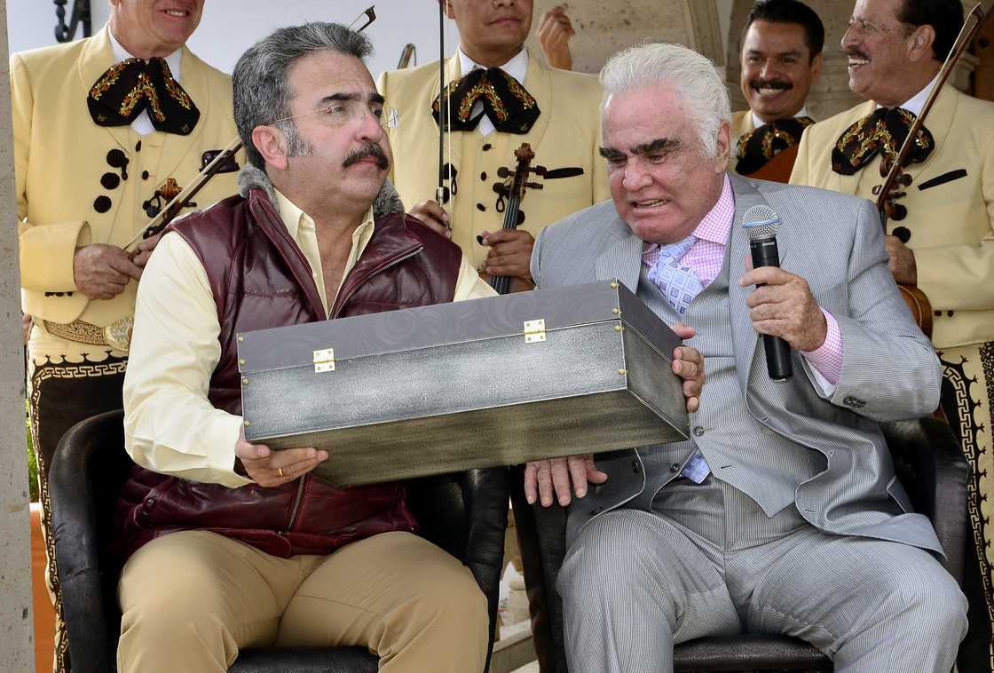 Vicente Fernández Jr shows his father, Vicente Fernández Sr, a special edition of the biographical book of Vicente Fernández at 'Rancho de Vicente Fernández, in México Vicente Fernández Jr shows his father, Vicente Fernández Sr, a special edition of the biographical book of Vicente Fernández at 'Rancho de Vicente Fernández, in México