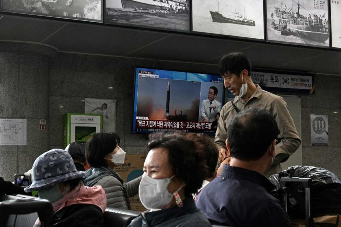Passengers at a ferry terminal on South Korea's eastern island of Ulleungdo watch television footage of a North Korean missile test Passengers at a ferry terminal on South Korea's eastern island of Ulleungdo watch television footage of a North Korean missile test