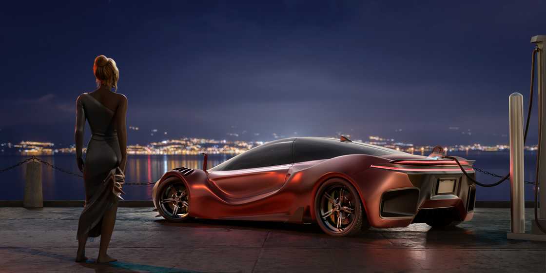 A woman near a Tesla at night. A woman near a Tesla at night.