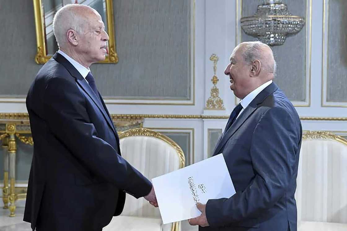 A handout picture provided by the Tunisian presidency on June 20 shows Sadok Belaid, head of Tunisia’s constitution committee, submitting a draft of the new constitution to President Kais Saied A handout picture provided by the Tunisian presidency on June 20 shows Sadok Belaid, head of Tunisia’s constitution committee, submitting a draft of the new constitution to President Kais Saied