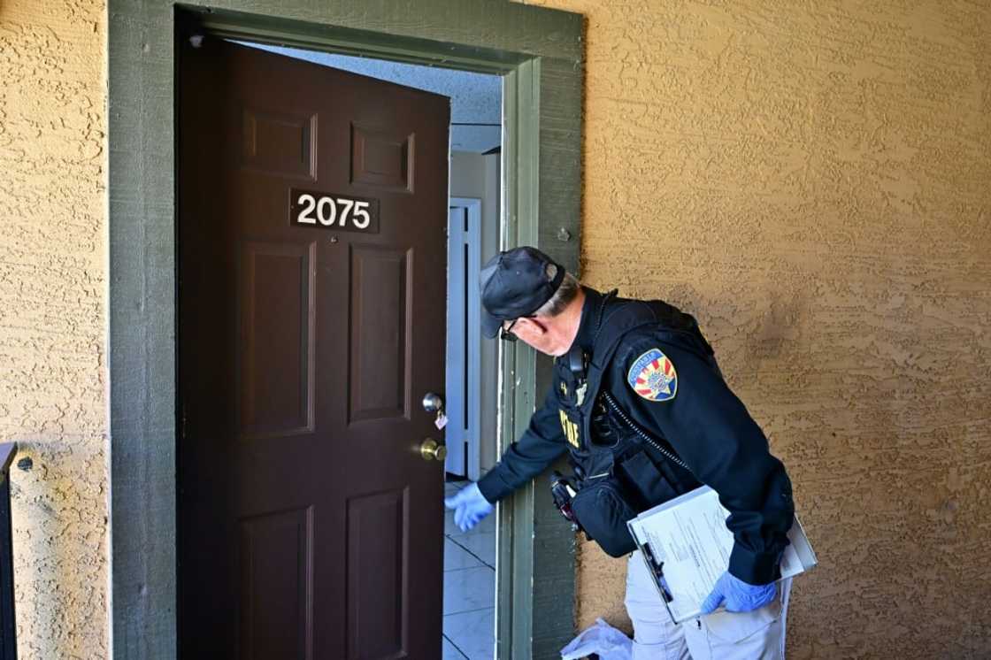 McCloskey pushes open the door to an apartment he needs to evict tenants from after getting no response from the doorbell and knocks McCloskey pushes open the door to an apartment he needs to evict tenants from after getting no response from the doorbell and knocks