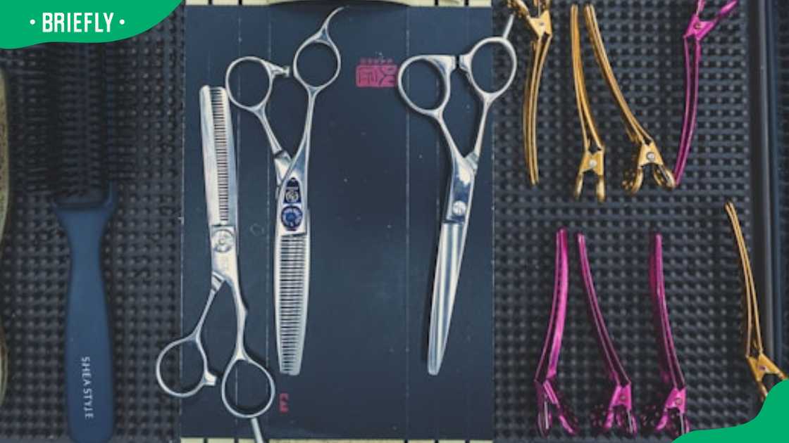 A bunch of scissors and a comb