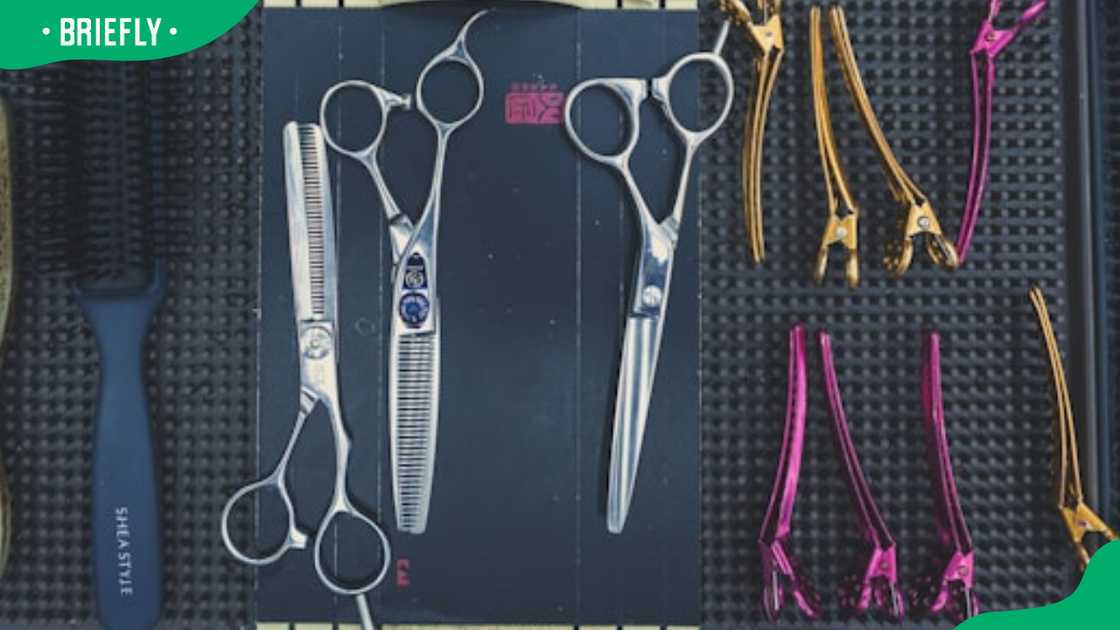 A bunch of scissors and a comb A bunch of scissors and a comb