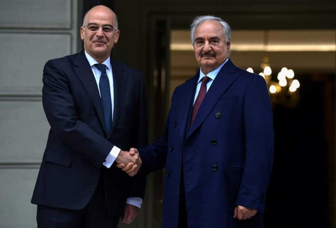 Greece has long favoured Libya's eastern strongman Khalifa Haftar (R) in his power struggle with the Turkish-backed government in the capital Tripoli