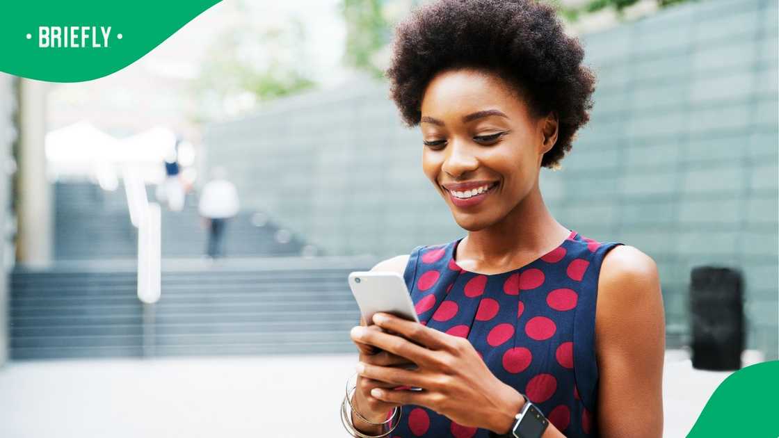 A woman smiles about a Xhosa couple's wedding. A woman smiles about a Xhosa couple's wedding.
