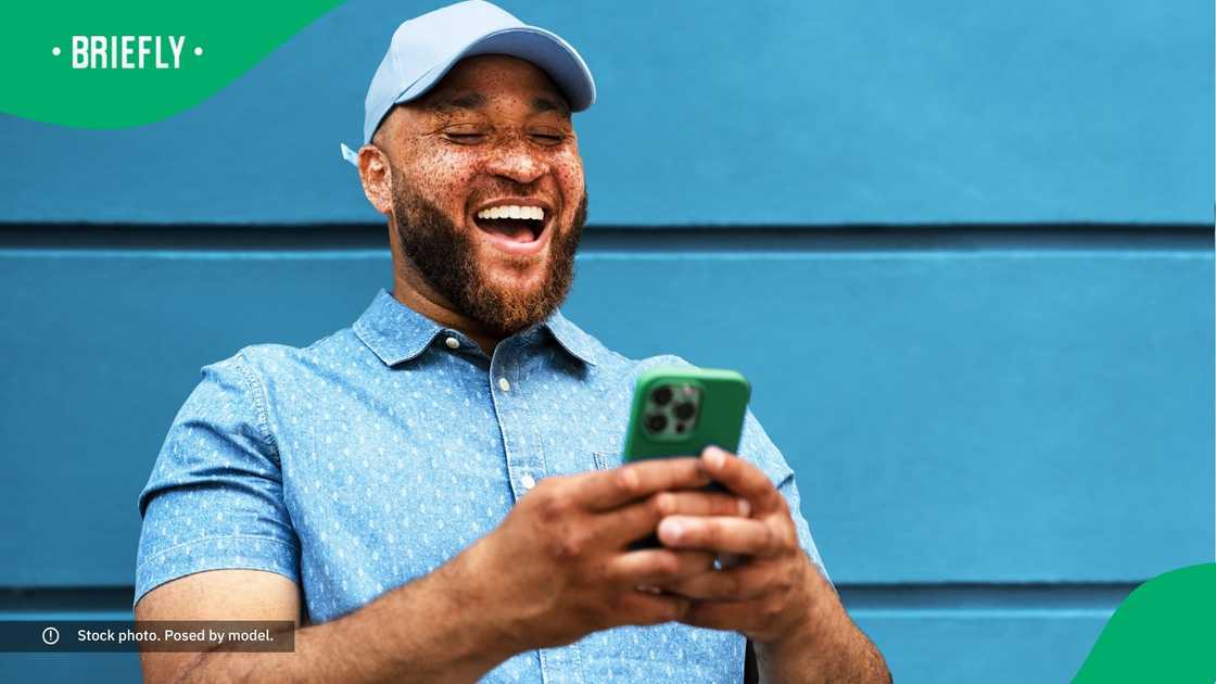 A man laughing at his phone.