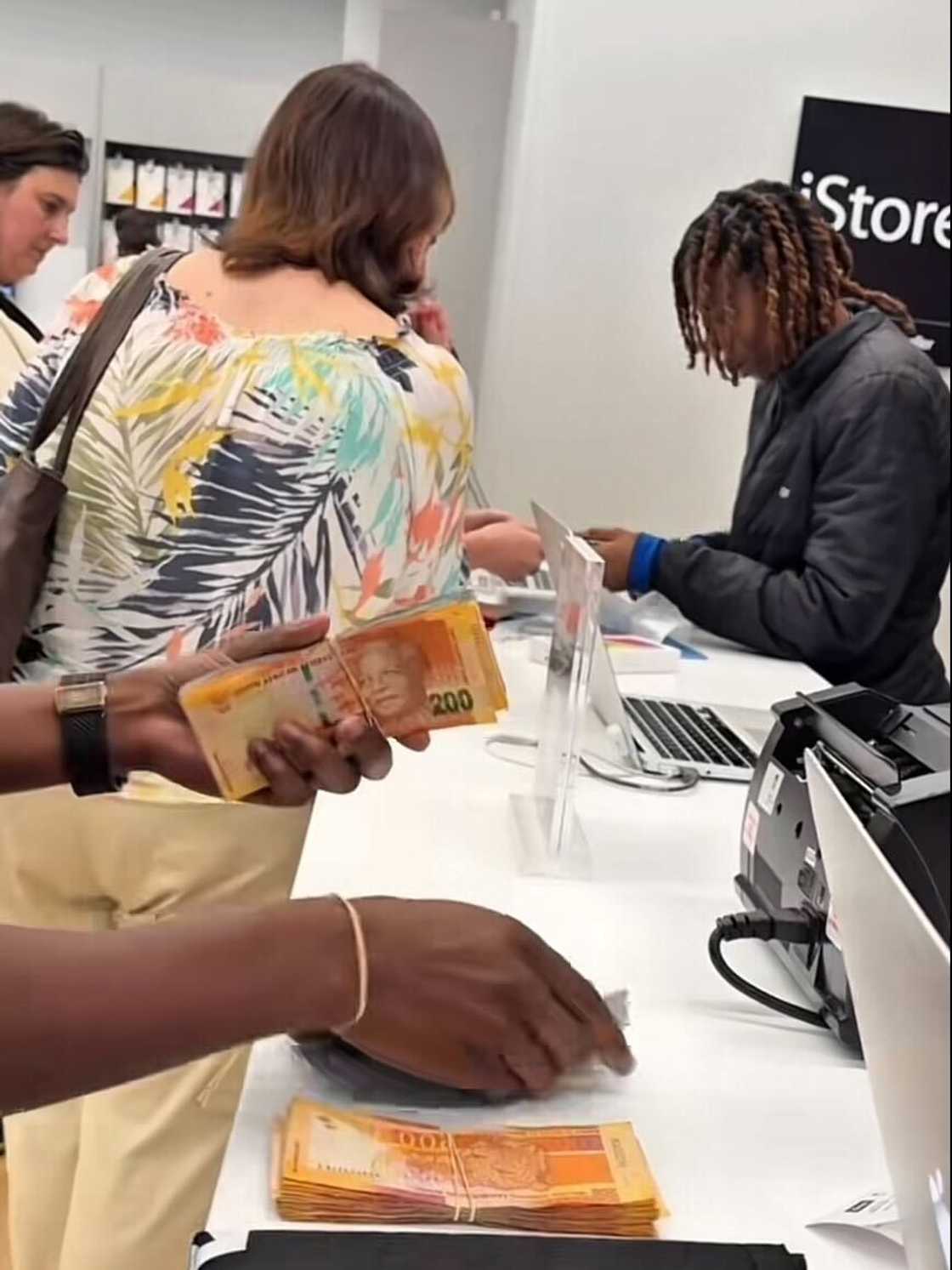 A man counting his cash in an iStore before buying an iPhone 17 Pro Max in Sandton, Johannesburg. A man counting his cash in an iStore before buying an iPhone 17 Pro Max in Sandton, Johannesburg.