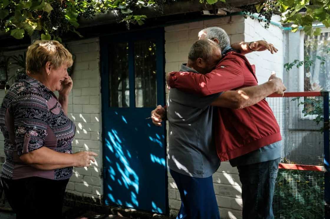 Ukrainians in the eastern village of Troitske reunite after the area was recaptured following a months-long occupation by Russia's army