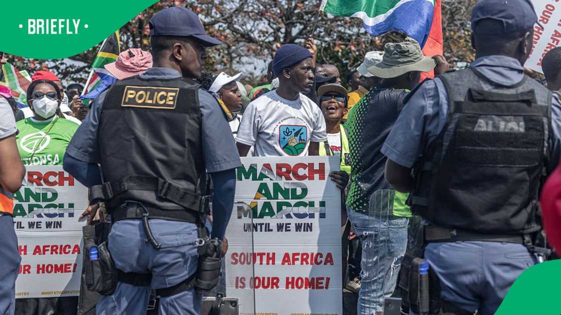 Protestors from the anti-illegal immigration group, March and March Movement hold placards and chant slogans during a demonstration in Durban, on September 10, 2026 Protestors from the anti-illegal immigration group, March and March Movement hold placards and chant slogans during a demonstration in Durban, on September 10, 2026