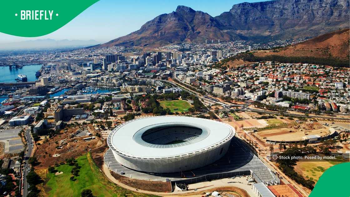 The curved structure of Cape Town Stadium was seen from above, framed by Table Mountain