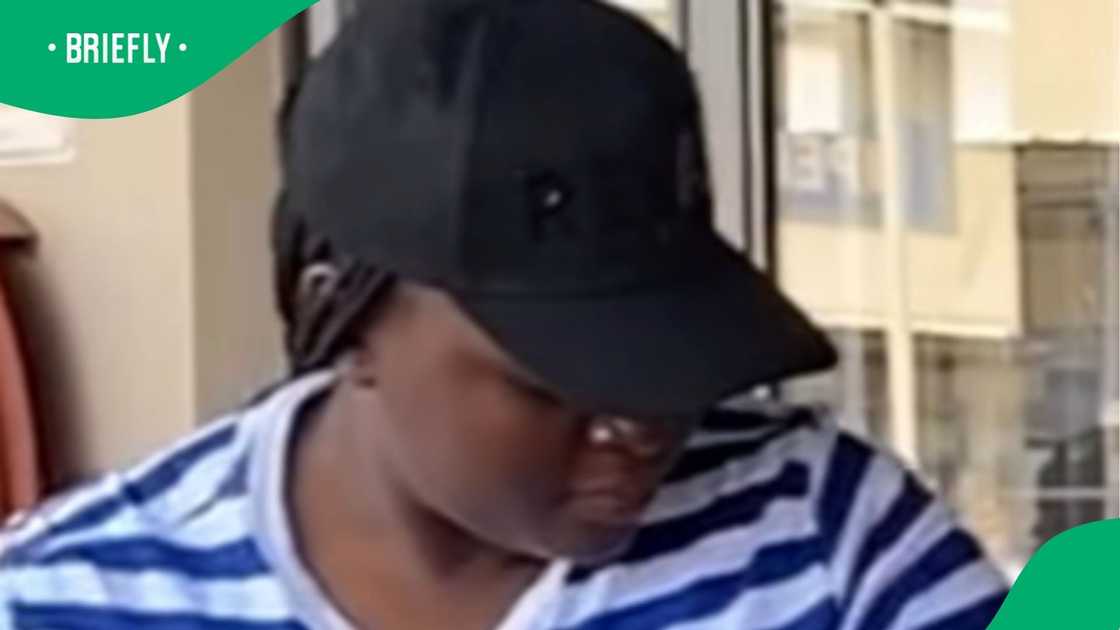 A woman standing at the entrance of a store. A woman standing at the entrance of a store.