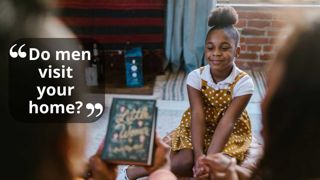 A young woman listens to adults indoors.