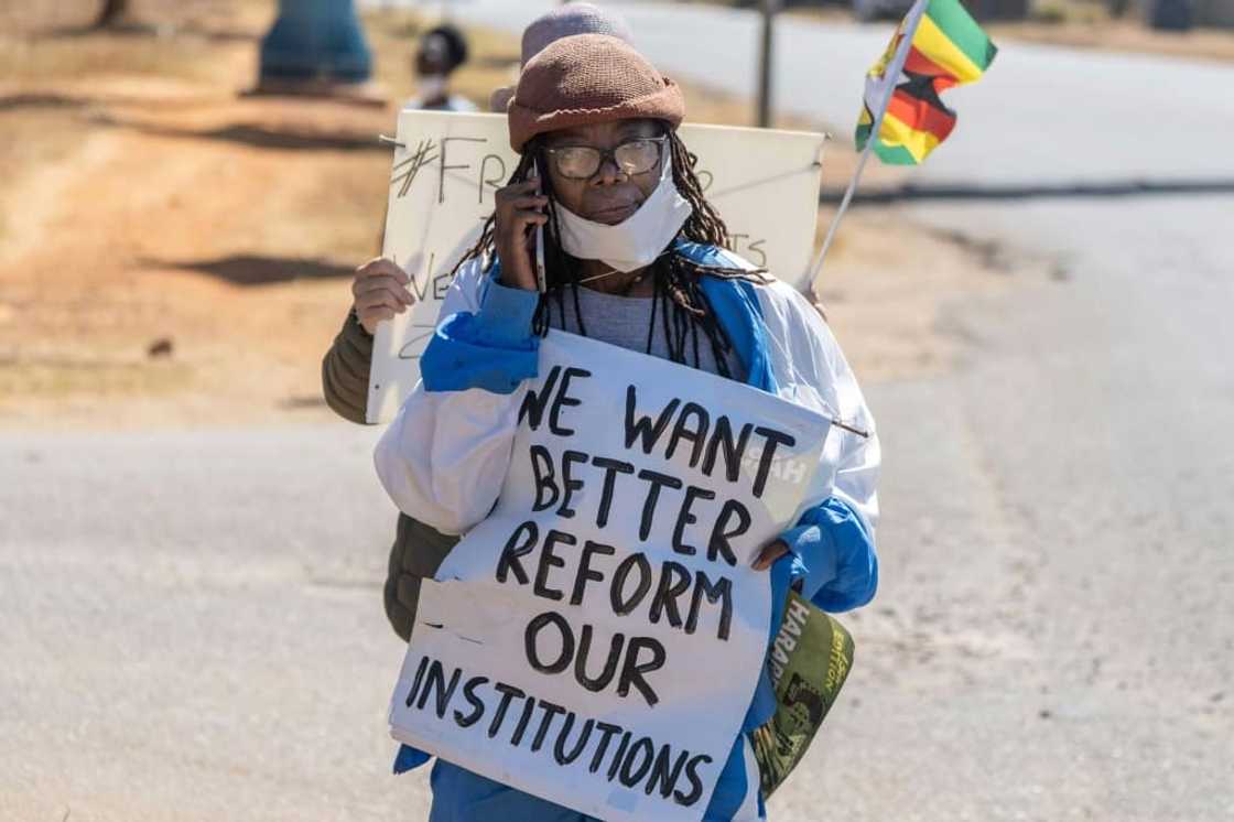 Writer Tsitsi Dangarembga was arrested for holding up a placard during a roadside protest with her neighbour in July 2020 Writer Tsitsi Dangarembga was arrested for holding up a placard during a roadside protest with her neighbour in July 2020