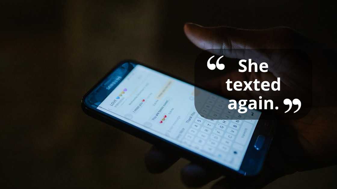 A hand holds a phone displaying text messages in the dark. A hand holds a phone displaying text messages in the dark.