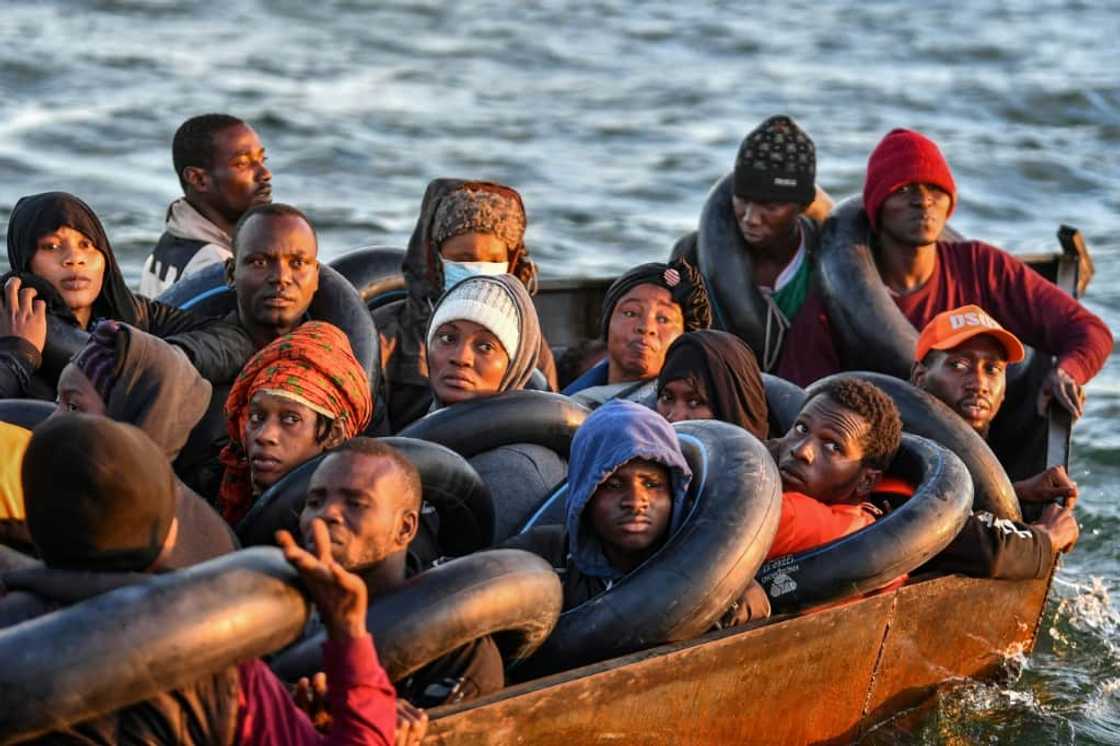 Migrants from sub-Saharan Africa stare dejectedly at Tunisian coastguards as they are intercepted in a barely seaworthy vessel 50 nautical miles out into the Mediterranean Migrants from sub-Saharan Africa stare dejectedly at Tunisian coastguards as they are intercepted in a barely seaworthy vessel 50 nautical miles out into the Mediterranean