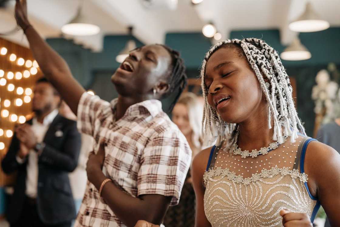 Congregants praise and sing during a church service. Congregants praise and sing during a church service.