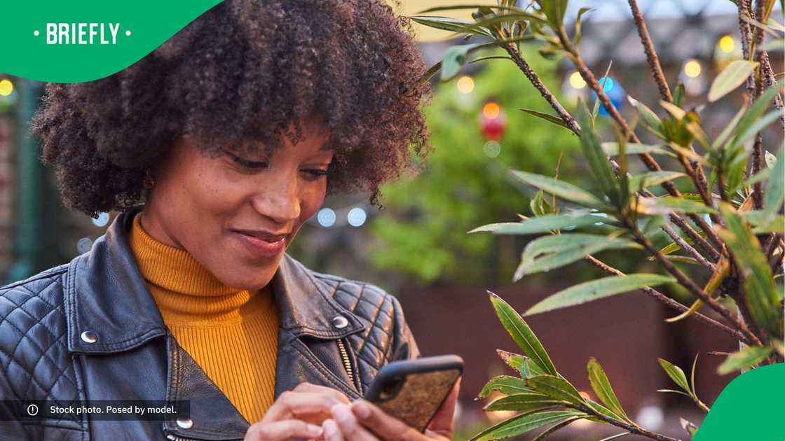 A woman typing on her phone.