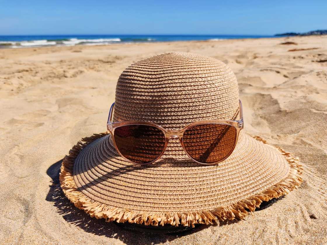 A close-up of hat on sand at beach A close-up of hat on sand at beach