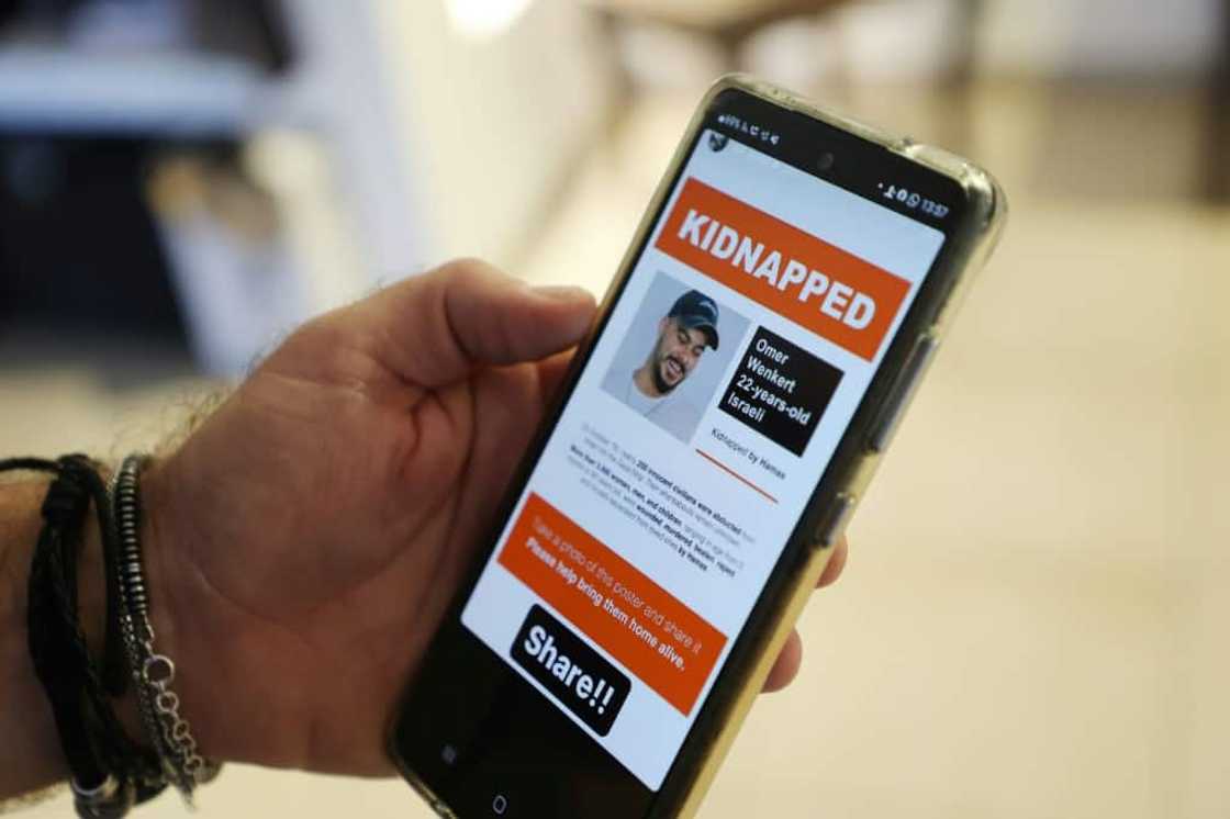 Shay Wenkert, the father of Israeli hostage Omer Wenkert who Hamas gunmen abducted from a music festival, shows an image of his son on a phone Shay Wenkert, the father of Israeli hostage Omer Wenkert who Hamas gunmen abducted from a music festival, shows an image of his son on a phone