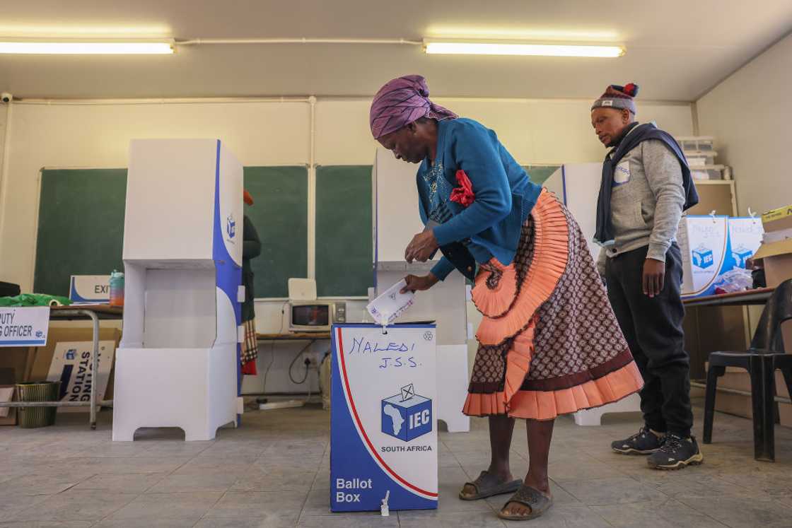 An IEC worker watches as a resident of Matatiele casts her ballot at the Naledi Junior Secondary School during the National Election on May 29, 2024 in Matatiele, South Africa An IEC worker watches as a resident of Matatiele casts her ballot at the Naledi Junior Secondary School during the National Election on May 29, 2024 in Matatiele, South Africa