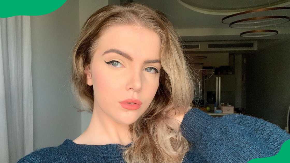 Loeya in a blue sweater dress. Loeya in a blue sweater dress.