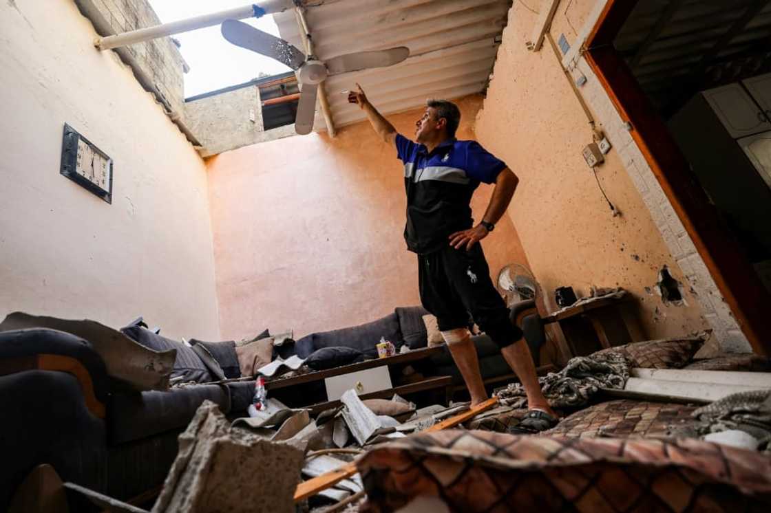 A man inspects damage to a house affected by an Israeli air strike at the Jabalia camp for Palestinian refugees in the northern Gaza Strip on August 6, 2022