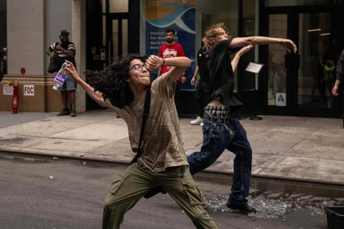 People throw ceramic plates and water bottles at police officers during riots sparked by Twitch streamer Kai Cenat, who announced a "giveaway" event in New York's Union Square on August 4, 2023 People throw ceramic plates and water bottles at police officers during riots sparked by Twitch streamer Kai Cenat, who announced a "giveaway" event in New York's Union Square on August 4, 2023