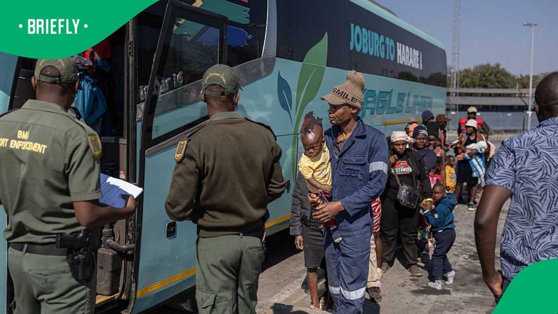 Border Management Authority (BMA) officers process people awaiting repatriation after they disembark from a bus at the Beitbridge border crossing between South Africa and Zimbabwe on July 9, 2026
