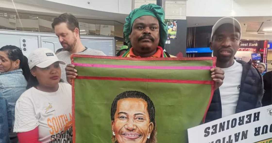 Rasta holding a portrait of Banyana Banyana's Desiree Ellis at OR Tambo Airport Rasta holding a portrait of Banyana Banyana's Desiree Ellis at OR Tambo Airport