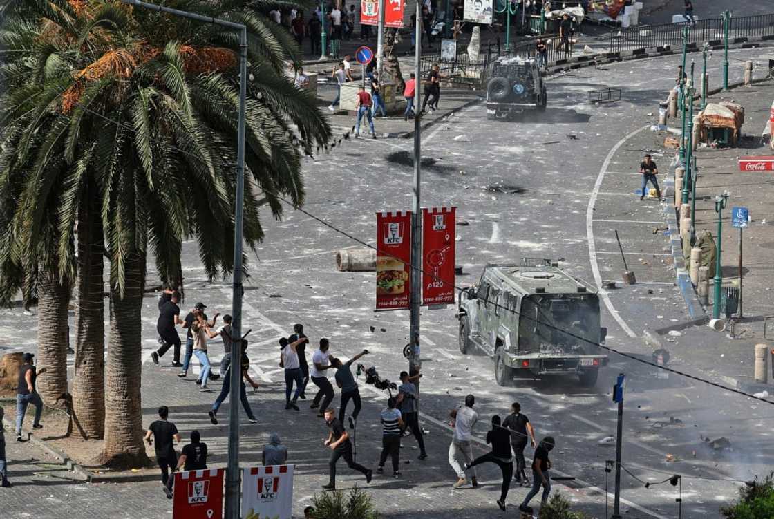 Young Palestinians engage in running battles with police in Nablus on Tuesday turning the heart of the West Bank city into a combat zone Young Palestinians engage in running battles with police in Nablus on Tuesday turning the heart of the West Bank city into a combat zone