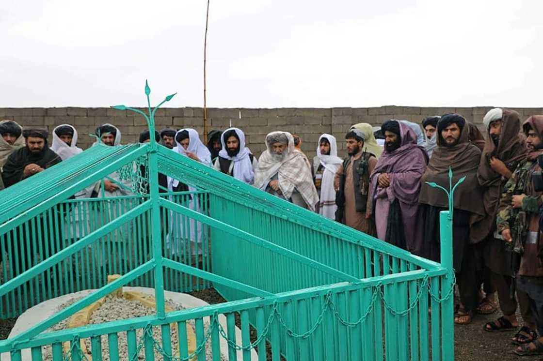 The Taliban released handout pictures of a ceremony held at the newly revealed gravesite of the movement's founder, Mullah Omar