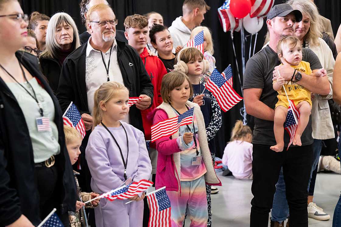 Afrikaners refugees wave USA flag upon arrival Afrikaners refugees wave USA flag upon arrival