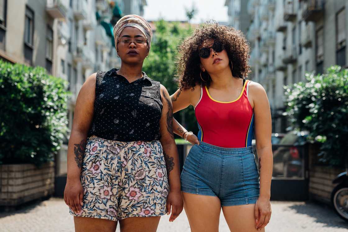 Two women wearing shorts. Two women wearing shorts.