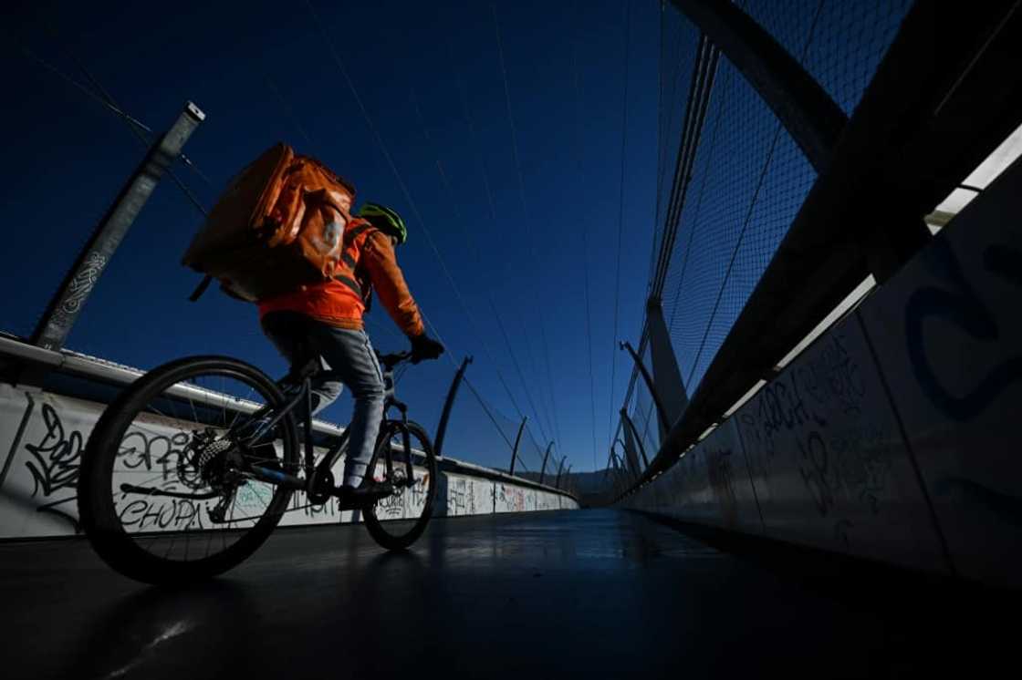A rider for Just Eat online food order and delivery brand, rides a bicycle in Turin on December 11, 2022. A rider for Just Eat online food order and delivery brand, rides a bicycle in Turin on December 11, 2022.
